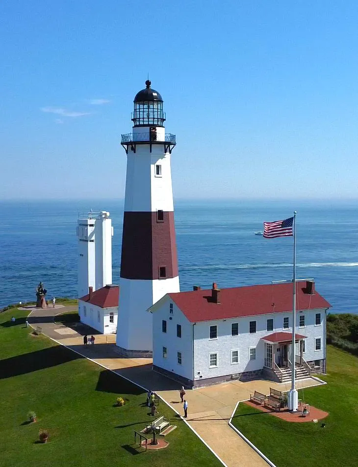 A lighthouse on a clear day overlooking the open sea.